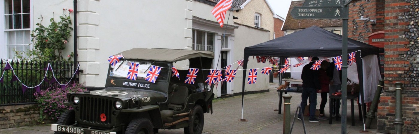 A USA Jeep stands guard outside the Eye Town Hall with Jubilee bunting blowing in the June breeze on Broad Street. A link to Eye