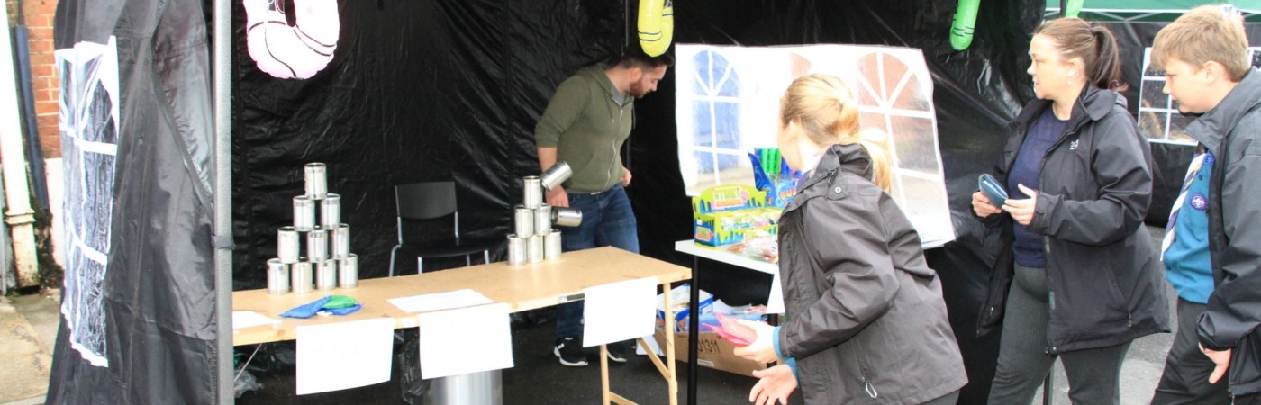 Crash the cans with the balls. A competitive game and fun too. Winning a prize can be fun.