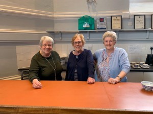 picture of the Town Hall Tea team of three ladies behind the tea bar