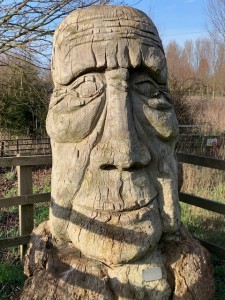The wooden carved Face greets you on Cranley Green Road Eye Suffolk